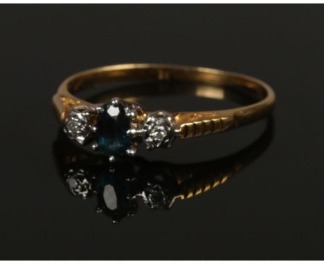 An 18ct gold diamond and sapphire ring. Size R. 2.37g.  