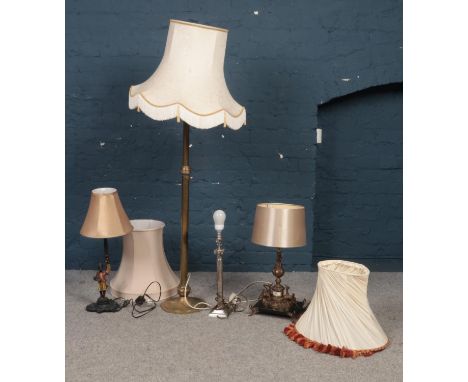 Four various lamps and shades. To include a brass adjustable floor lamp with shade and three decorative desk lamps with two e