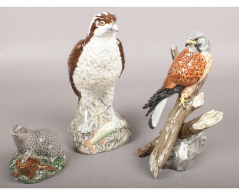 A full and sealed Beswick Osprey Beneagles whiskey decanter along with an empty Beswick badger and a figure of a Kestrel.  