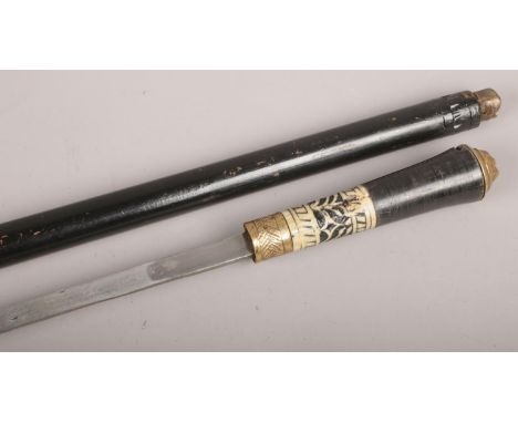 An Indian ebonised sword stick with brass lion mask pommel.  
