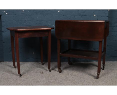 Two wooden tables/trolley's on casters.  Comprising of a drop leaf trolley with shelf as example. Smaller Table: H:60cm,W:55c