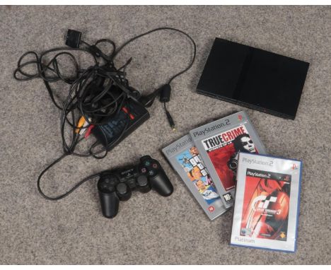A Playstation 2 slimline console. With two games.  Grand Theft Auto case empty. Unsure if in working order.