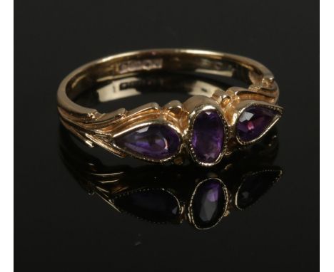 A 9ct gold 3 stone amethyst ring. Assayed Edinburgh 1992. Size K, 1.66g.  