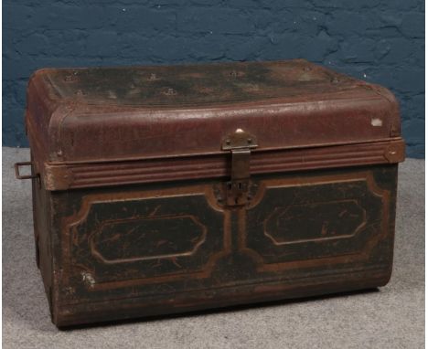 A vintage dome top twin handled tin trunk.  