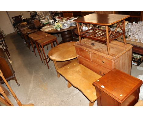 A mid-20th Century circular oak coffee table; a rustic bench; a stripped pine chest and a cane two tier table 