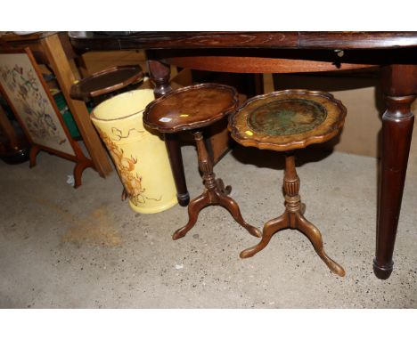 A stick stand and three wine tables raised on tripod bases 