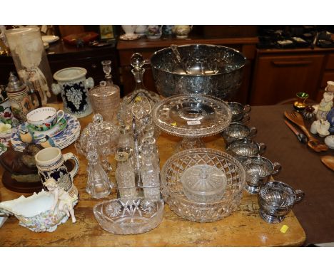 A silver plated punch bowl, cups and ladle; a collection of table glassware to include decanters, stands, cruet set etc.