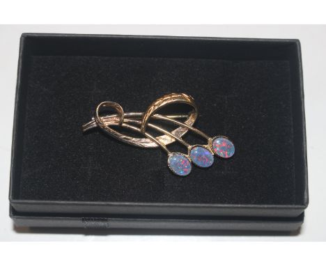 A silver gilt and opal brooch