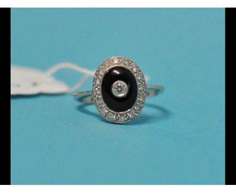 An Art Deco style 18ct white gold, onyx and diamond cluster ring, approx. ring size M