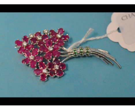 A silver, ruby and emerald floral spray brooch