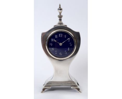 An Edwardian silver mounted timepiece, the 5 cm diameter enamel dial indistinctly inscribed and with Arabic numerals, in a va