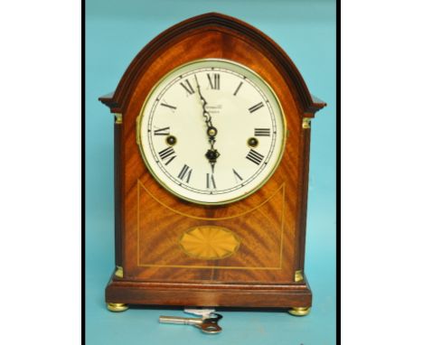 A Comitti mantel clock, the dial with Roman numerals, in a mahogany case, 31 cm high