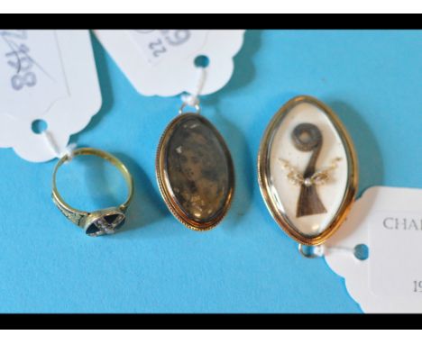 A 19th century mourning brooch/pendant, a similar portrait brooch, and a 15ct gold, pearl and enamel mourning ring (3)