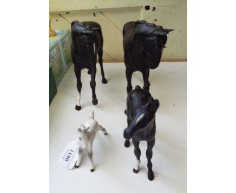 EXTRA LOT: A Beswick Black Beauty, 2466, another, and a foal, 2536, and a foal, small, stretched, facing left, grey, 997, glo