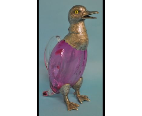 A ruby and clear glass decanter, in the form of a duck, with plated mounts, 26.5 cm high