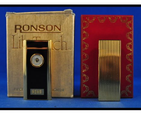 A Must de Cartier cigarette lighter, and a Ronson Lite Touch cigarette lighter, both boxed (2)