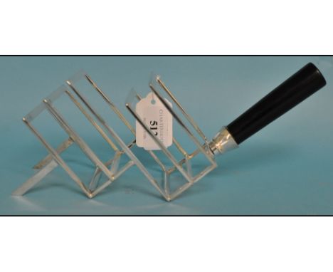 A Dr Christopher Dresser style toast rack Condition report Report by GH

Modern reproduction item. Good condition with no obv