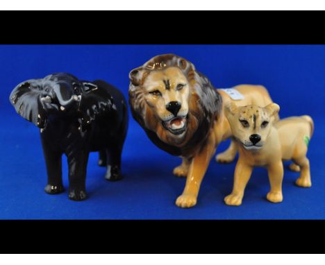 A Beswick Elephant, trunk stretching, small, 974, a Lion, facing left, 2089, and a Lion Cub, facing left, 2098, all gloss (3)