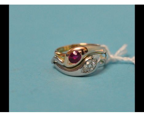 A yellow and white coloured metal entwined serpent ring, set a ruby and a diamond, approx. ring size J