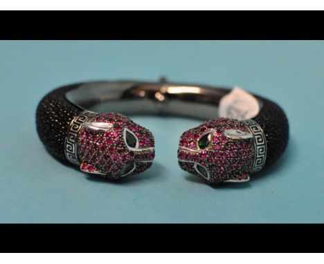 A silver and ruby set panther bangle