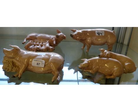 A collection of four ceramic pigs by Creamware