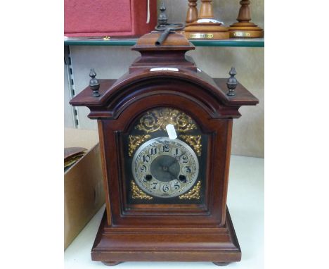 An early 20th century walnut cased bracket style mantel clock