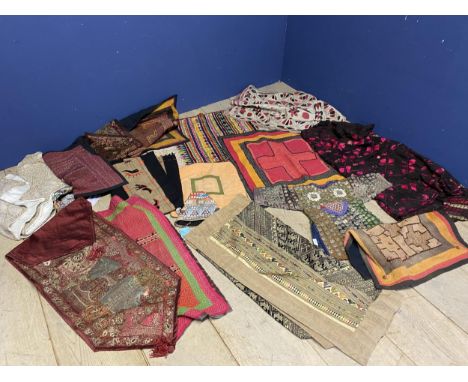 A quantity of textiles, including wall hangings from Myanmar, and a ethnic/tribal tunic, decorated all over with beading, cow