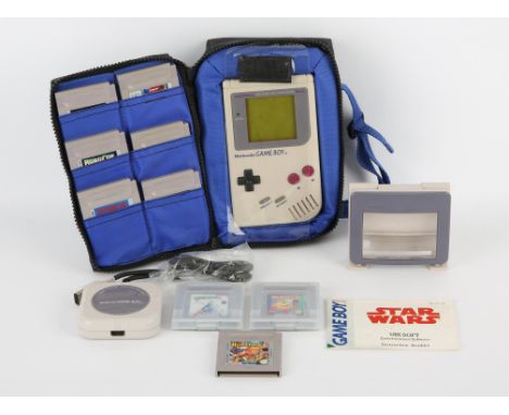 Nintendo Game Boy system in a third party zip-case with 12 games (PAL), Light Booster magnifying accessory and Four-Player ad