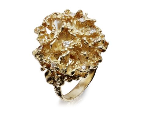 A 1970s diamond set ring  of textured scrolling design, set at intervals with small round brilliant cut diamonds, to a textur