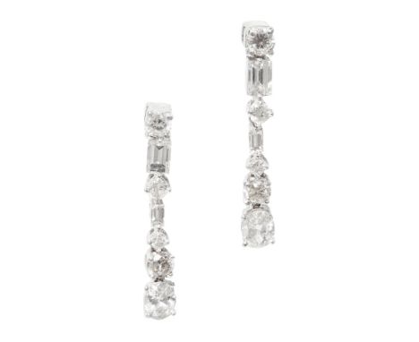 A pair of pendant diamond earrings  each composed of a row of alternating graduated round cut and baguette diamonds, terminat