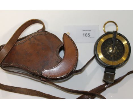 A CASED COMPASS. A cased military sighting compass by H Hughes & son London. Marked Creagh Osborne on the brass dial, floatin