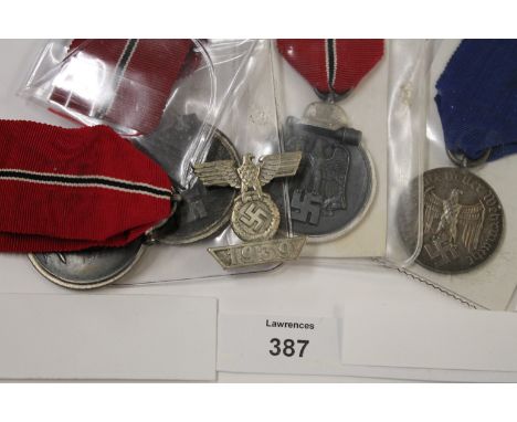 GERMAN MEDALS etc. 3 x Winter War medals, one of which has 20 on the suspension ring. An armed forces long service award. 2nd