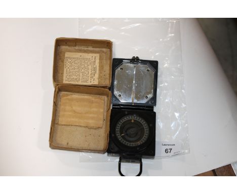 A BOXED MARCHING COMPASS. A T.G.Co. Ltd Mk 1 magnetic marching compass, with broad arrow mark in its original cardboard box w