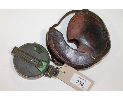 A CASED SIGHTING COMPASS. A leather cased blackened brass sighting compass, Patent No 1926, 3287. With fitted device to place