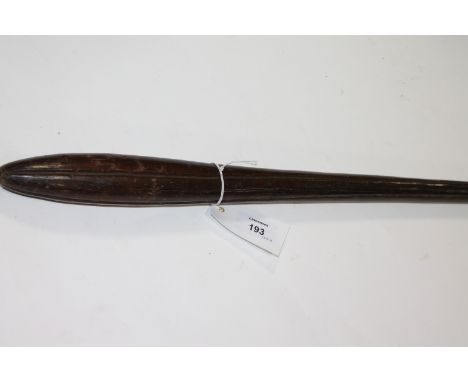 A THROWING CLUB. A hardwood throwing or hunting club, with linear carved decoration. Cross cut grip, with an overall length o