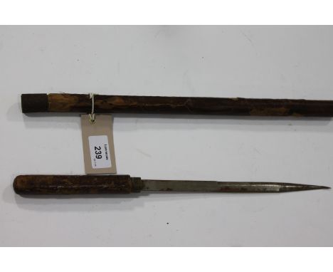 A SWAGGERSTICK WITH CONCEALED DAGGER. An officers walking out stick at one time leather covered, with concealed 9" stiletto b