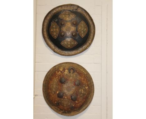 TWO 19thC INDIAN SHIELDS. Two large round 19thC shields with ornate decoration in profusely painted details. The diameter of 