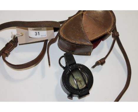 A CASED MILITARY COMPASS. A cased 1940 dated T G & Co Ltd London, Mk 111 numbered B77837.
