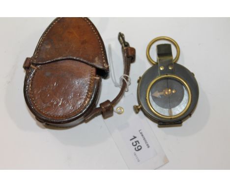 A MILITARY COMPASS. A leather cased blackened brass officers compass, with WD marking and Pulley & Powell 1916 on the case.