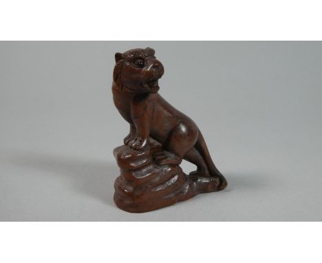 A Carved Wooden Netsuke in the Form of Growling Tiger Upon Rock, 6cm High 
