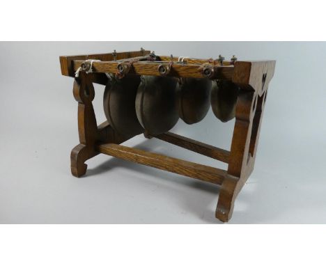 A Vintage Black Forest Percussion Instrument in the Form of Four Graduated Cow Bells Suspended on Pierced Wooden Frame, 31cm 