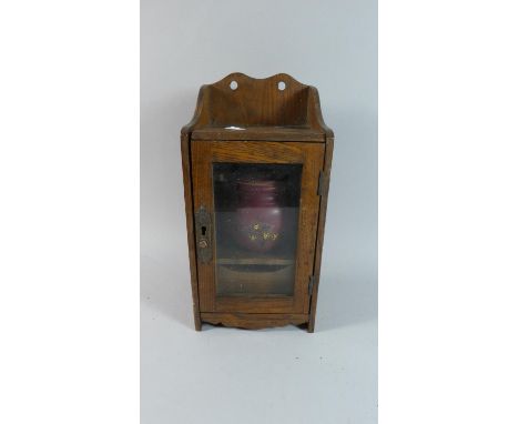 An Edwardian Oak Smokers Box with Glazed Door to Fitted Interior with Pipe Rack and Drawer, Ceramic Tobacco Pot, 32cm High 