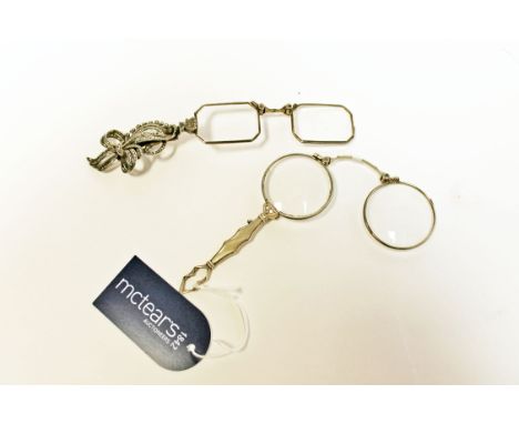 GERMAN SILVER LORGNETTEwith macastie bow-design terminal; together with another lorgnette (2)