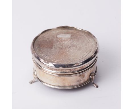 A circular trinket box on three feet with cartouche and monogrammed lid probably silver but no hallmark found, diameter 8cm.