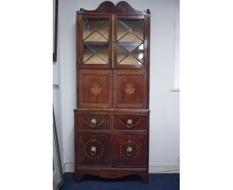 An Edwardian mahogany side cabinet, the upper section fitted with a pair of glazed door, over a 2 door cupboard with marquetr