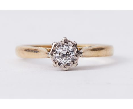 An 18ct yellow gold single stone ring set with a round cut diamond in an illusion setting, approx. 0.15 carats, 2.83gm, size 