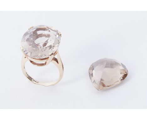 A 14k yellow gold cocktail ring set with a large oval cut smokey quartz?, ring stamped 'Scalle 14k', 8.46gm and a large loose