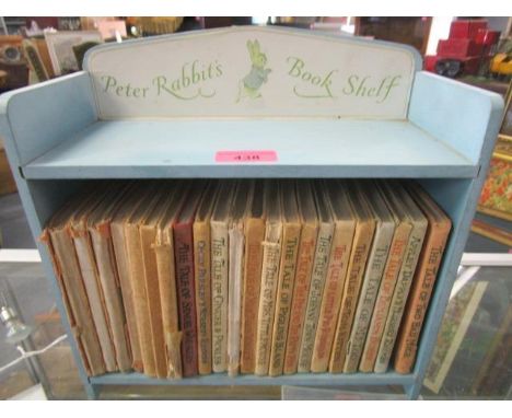 A part set of Beatrix Potter Peter Rabbit books in a painted Peter Rabbit book shelf 