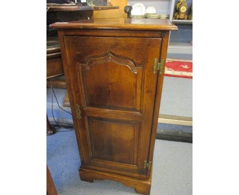 A Cumpers of Salisbury oak revolving CD cabinet having two panelled doors revealing fitted shelves, 33" h x 16"w 