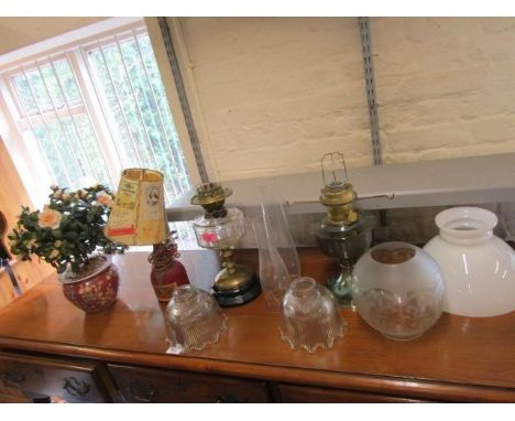A mixed lot of oil lamps with glass shades and smoke funnels, a table lamp and shade, and an Oriental porcelain jardiniere wi
